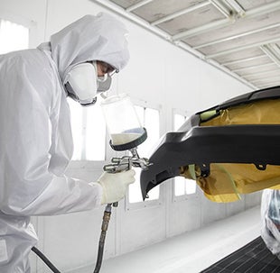 Collision Center Technician Painting a Vehicle | Romeo Toyota of Glens Falls in Glens Falls NY