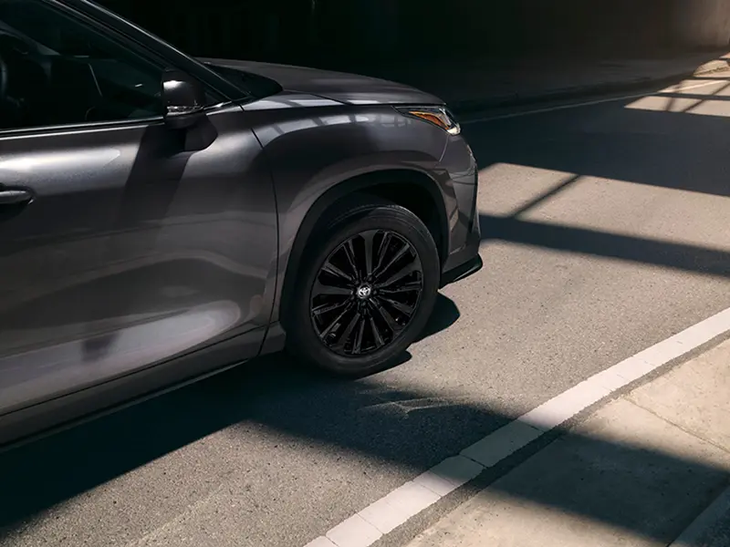 Close-up of a gray Toyota SUV wheel and tire on pavement